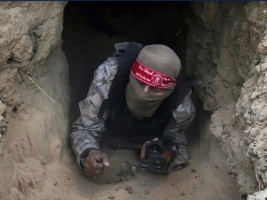 A Hamas fighter emerging from a Gaza tunnel.